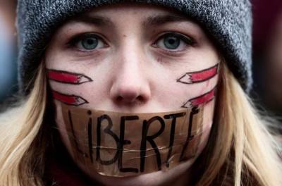 Woman protests outside the French embassy. Free speech?